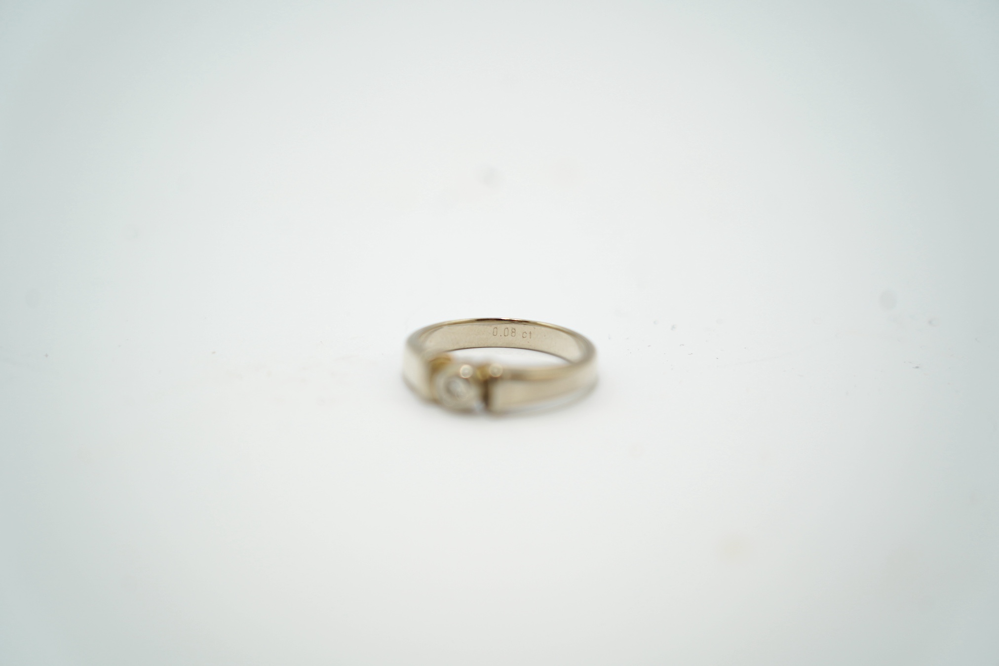A mid to late 20th century Polish 583 standard white metal and solitaire diamond chip set ring, size N, gross weight 4.3 grams. Condition - fair